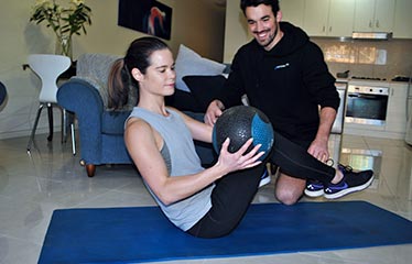 Functional For Life trainer taking client through an at home workout session
