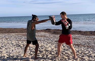 on beach boxing personal training session water sand