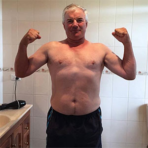 man flexing arms after weight loss